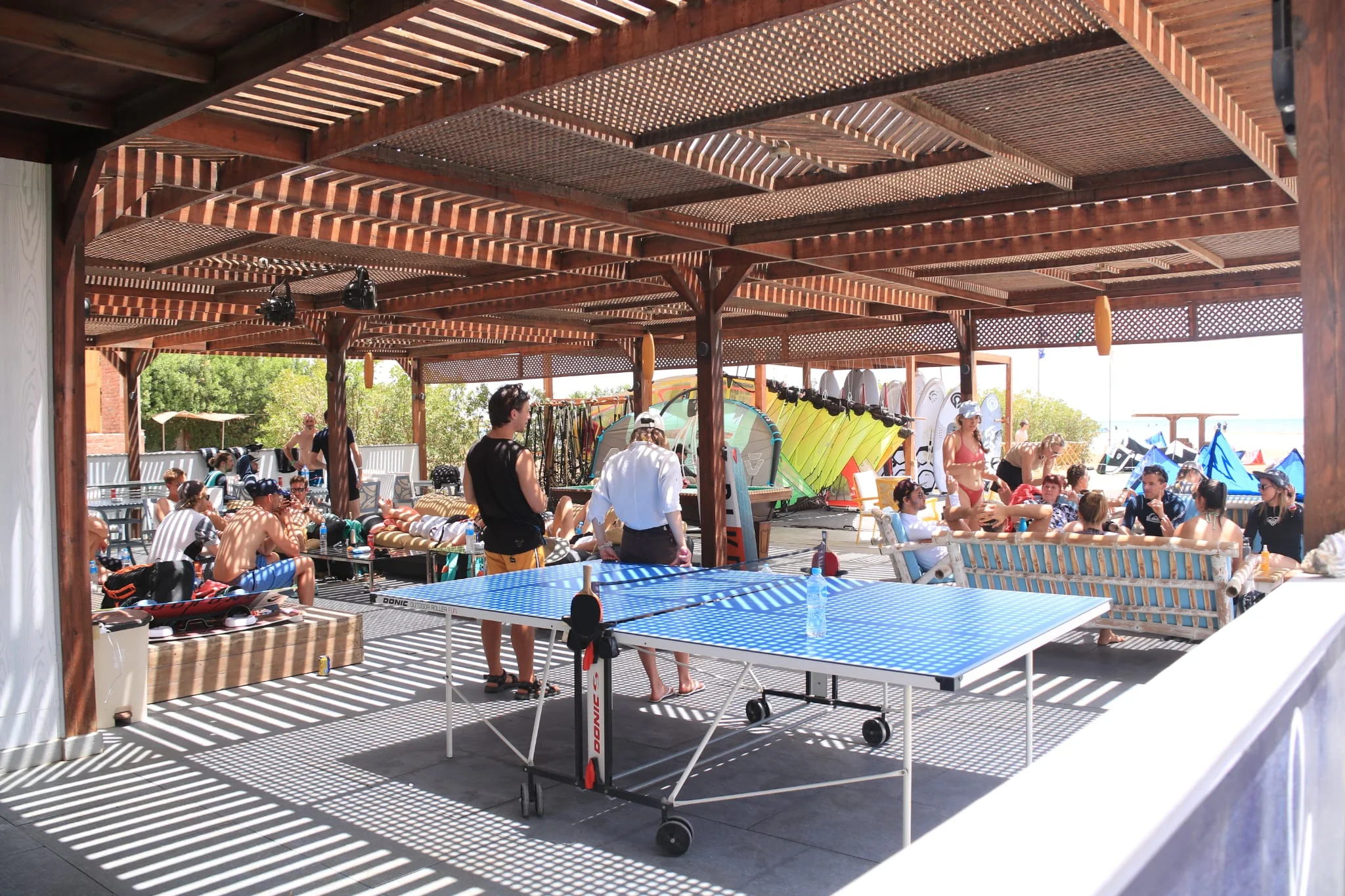 Kitesurfing camp with people learning and riding kites